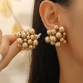 Macro shot of gold clustered bead earrings with a polished metallic finish on model - Gold Stud Earrings (01 kc Gold A-553)