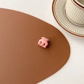 Close-up of a small pink matte hair claw clip on a brown leather surface - Matte Pink (Small Approx. 2cm)