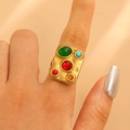Close-up of a 18K gold-plated sunflower ring with a large red center gemstone - Multi-color Gemstone Square (9512)