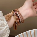 Bracelet multicouche bohème en perles avec pompon et breloques en métal marron - Style de Gland de Cristal Multicouche de Perles de Riz