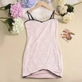 Close-up of pink floral lace fabric with black trim on a slim fit bodycon cami dress - S / Pink