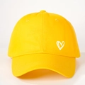 Detailed close-up of yellow cotton baseball cap with embroidered white heart pattern - One Size / Bright Yellow