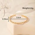 Minimalist gold-plated stainless steel cuff bracelet with geometric disc texture - Continuous Disc Geometric