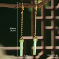 Detail shot of long gold earrings with green jade-like pendants on wooden background - Long Emerald Green Pendant (GF0076)