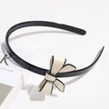 Elegant black non-slip headband featuring a white bow accent on a clean background - Beige Bowknot