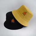 Detail of embroidered orange fruit and text on black and yellow reversible bucket hats - Adult 55-58cm / Orange Yellow