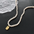 Baroque pearl necklace with gold square pendant and star motif on black background - 03-C10 Titanium Steel Square Natural Pearl Necklace