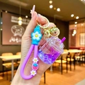 Close-up of purple liquid shaker keychain with silicone strap and floral charm detail - Strawberry Strap Purple Luminous Dried Flower Iceberg Cup