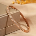 Macro shot of rose gold titanium steel bracelet with full square zircon inlay on satin - Single Row / Rose Gold