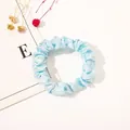 Close-up of light blue satin scrunchie with soft pleated texture and high-gloss finish - Satin Thin Scrunchie-Sky Blue