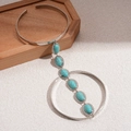 Detail of vintage silver arm cuff with turquoise beads on a natural wooden display - One Size(Adjustable) / Silver