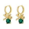 Close-up of golden bow earrings with square green gemstone in claw setting - Gold Green Zircon Gift Bag