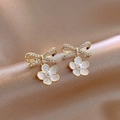 Close-up of golden bow flower earrings with pearls on elegant champagne silk fabric - 80# Silver Pin Flower Hoop