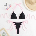 Flat lay of pink and black bikini set with straw hat and sunglasses for summer beach holiday - Black + Pink Cord