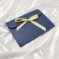 Navy blue envelope gift box with a yellow ribbon bow on a white silk background - Navy Blue