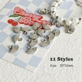 Macro detail of 15x12mm silver fan pendants for DIY jewelry and Y2K necklace making - Style 11 Fan