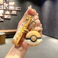 Eevee themed Poke Ball keychain with Pikachu lanyard held in hand at a cozy cafe - B344-3 Brown Eevee / Large