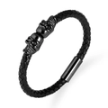 Pulsera de cuero negro trenzado con doble calavera y cierre magnético sobre blanco - Negro