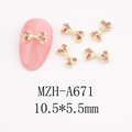 Macro detail of 10.5x5.5mm pink rhinestone bow nail art charm with gold metal frame - Rounded Bowknot (A671)