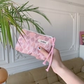 Macro detail of pink heart jacquard fabric pouch with zipper and woven lanyard - Embossed Heart