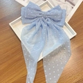 Close-up of a light blue chiffon bow hair clip with white Swiss dots and long ribbons - Long Streamer Spring Clip / Blue Polka Dot