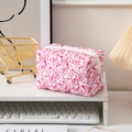 Pink floral quilted cotton toiletry bag with zipper on a desk and aesthetic background - Red Floral