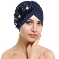 Detail of navy blue turban hat featuring 3D floral petals and elegant pearl center - Navy Blue