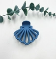 Blue shell-shaped matte hair claw clip for women styled with eucalyptus leaves - Sapphire Blue