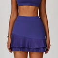 Completo sportivo viola scuro con gonna a pieghe a vita alta e reggiseno sportivo - S / Blu Rosato