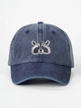 Detailed view of the washed denim raccoon embroidery on a dark blue retro baseball cap - Navy Blue