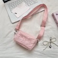 Pink nylon crossbody bag featuring delicate bow embroidery and a pearl heart charm - Light Pink