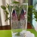 Detailed macro view of purple gradient cicada wing earrings hanging on a glass cup - Purple Silver Foil