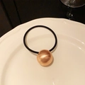 Elastic hair tie featuring a rose gold brushed metal sphere bead on a black cord - Brushed Style / Rose Gold