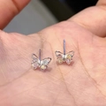 Elegant S925 silver butterfly earrings with colorful inlaid gems shown in palm - Colorful Zircon Butterfly Studs - A1120 Silver