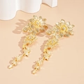 Macro shot of gold floral earrings with intricate leaf patterns and sparkling crystals - Silver Earring Post - Large Gold Flower Earrings