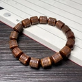 Dark rosewood bracelet with cylindrical beads engraved with the Six-Word Mantra charm - 12mm Barrel Bead Six-Word Mantra