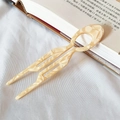 U-shaped acetate hair pin with amber marble pattern for elegant bun hairstyles - Creamy Floral