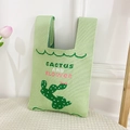 Detail of light green knit tote bag featuring a stitched cactus and textured weave - Green Cactus Bag