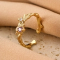 Adjustable golden bow ring with purple and white crystals on textured stone base - Gold Purple Lava Zirconia Ring (4225)