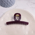 Detail of large dark purple hair claw clip with golden spring on ceramic tray - Cherry - Butterfly Buckle Straight (Approx 11.3cm)