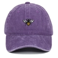 Close-up of a vintage washed purple baseball cap with detailed bee embroidery and eyelets - Purple