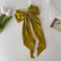 Elegant olive green satin bow hair clip with long ribbons on a white background - Turmeric