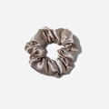 Detailed view of high-gloss champagne satin scrunchie with soft silk texture folds - Gray
