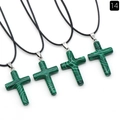 Set of four natural green malachite cross pendants with black cords on white background - Malachite (Synthetic)