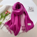 Detail of rose and pink cashmere-feel scarf with fringe and label on tweed jacket - Rose Purple