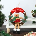 Detail der Weihnachtskranz mit Lebkuchenmann Puppe und Feliz Navidad Banner Schild - Lebkuchenmann mit rotem Hut Kranz