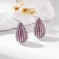 Close-up of silver copper teardrop stud earrings with magenta cubic zirconia crystals - Purple