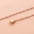 Close-up of rose gold water wave chain necklace with lobster clasp on pink fabric - 2mm 45+5cm Necklace / Rose Gold