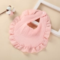 Detail of pink cotton muslin baby bib with ruffle edges and secure snap fastener - Dusty Pink