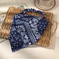 Elastic navy blue paisley bandana headband on a rustic rattan tray with a cozy aesthetic - Navy Blue